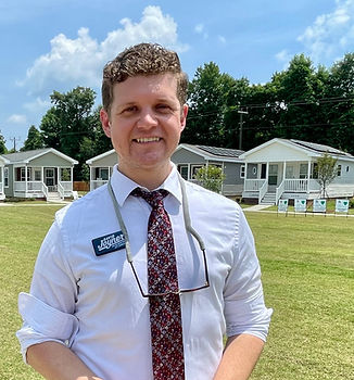 David Joyner in front of houses